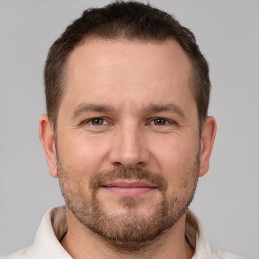 Joyful white adult male with short  brown hair and brown eyes