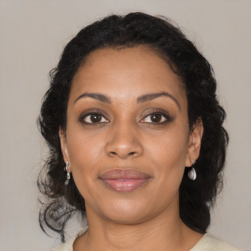 Joyful black young-adult female with medium  brown hair and brown eyes