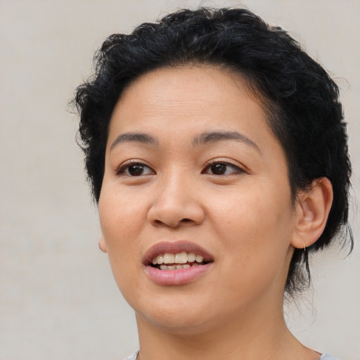 Joyful latino young-adult female with medium  black hair and brown eyes