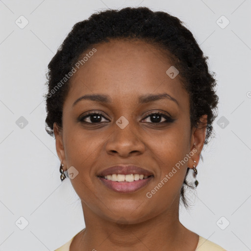 Joyful black young-adult female with short  brown hair and brown eyes