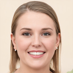 Joyful white young-adult female with long  brown hair and blue eyes