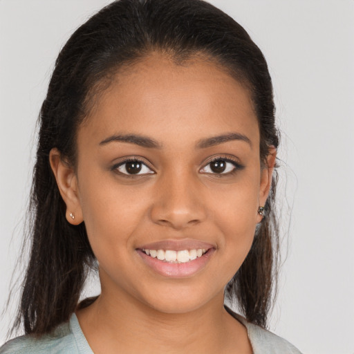 Joyful black young-adult female with medium  brown hair and brown eyes