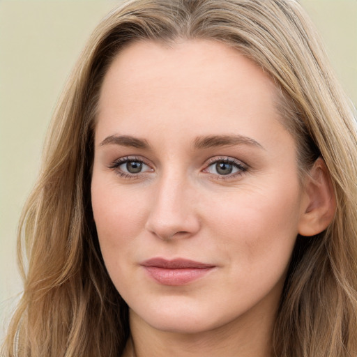 Joyful white young-adult female with long  brown hair and blue eyes