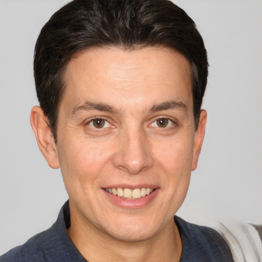 Joyful white adult male with short  brown hair and brown eyes