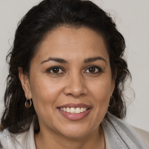 Joyful white adult female with medium  brown hair and brown eyes