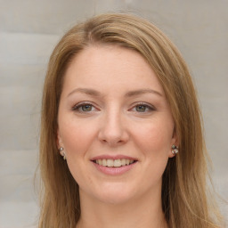 Joyful white young-adult female with long  brown hair and grey eyes