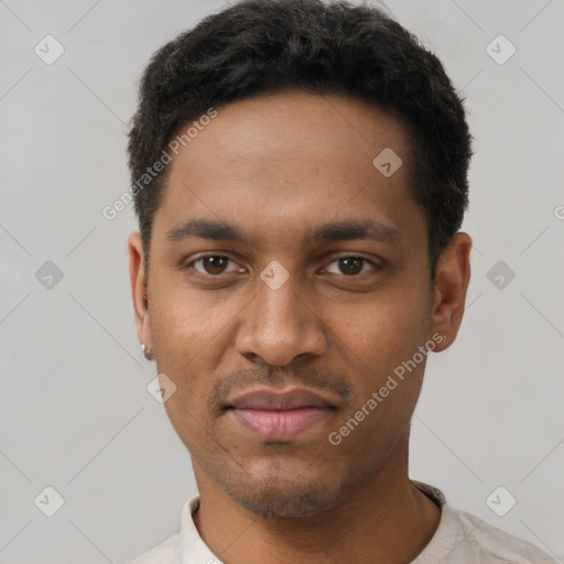 Joyful black young-adult male with short  black hair and brown eyes