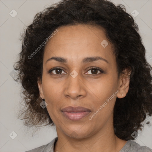 Joyful black adult female with medium  brown hair and brown eyes