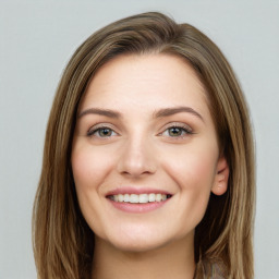 Joyful white young-adult female with long  brown hair and green eyes