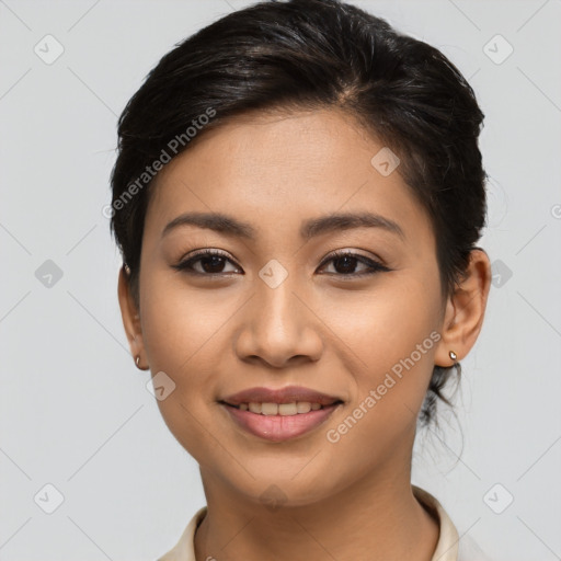 Joyful latino young-adult female with medium  brown hair and brown eyes