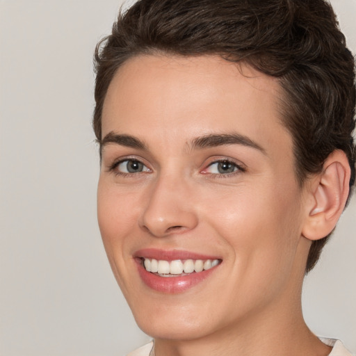 Joyful white young-adult female with short  brown hair and brown eyes