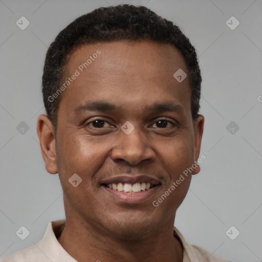 Joyful latino young-adult male with short  brown hair and brown eyes