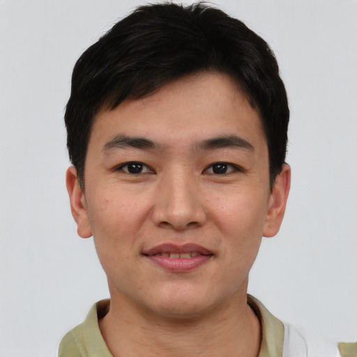 Joyful asian young-adult male with short  brown hair and brown eyes