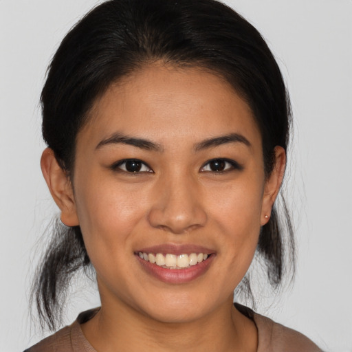 Joyful asian young-adult female with medium  brown hair and brown eyes