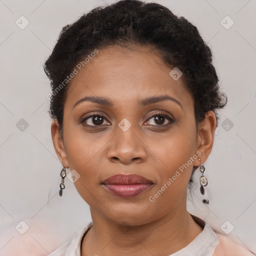 Joyful black young-adult female with short  brown hair and brown eyes