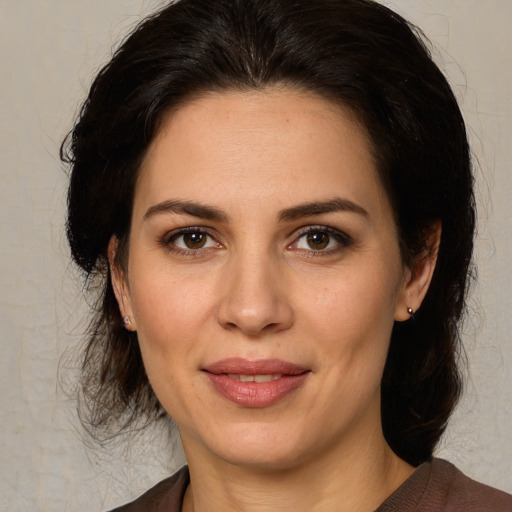 Joyful white adult female with medium  brown hair and brown eyes