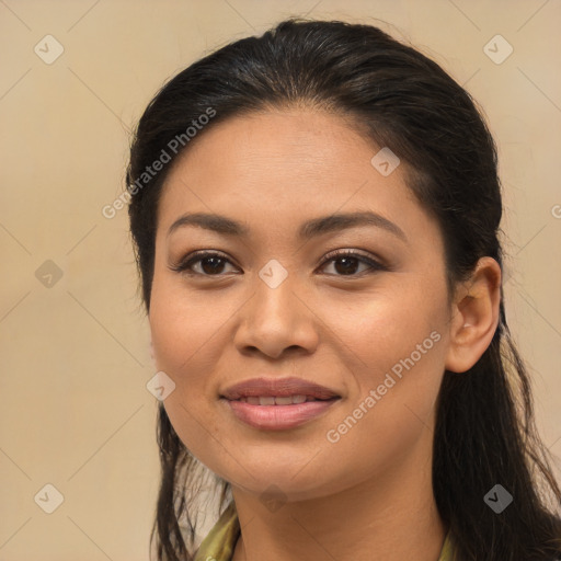 Joyful latino young-adult female with long  brown hair and brown eyes