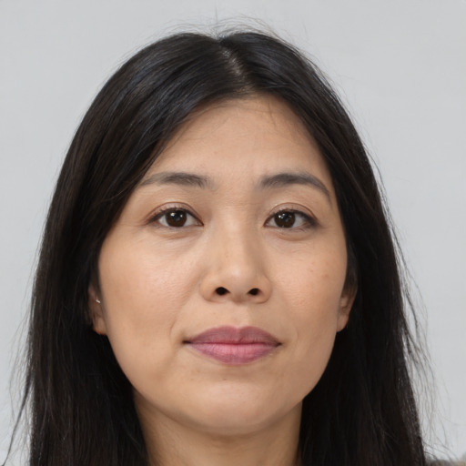 Joyful asian young-adult female with long  brown hair and brown eyes