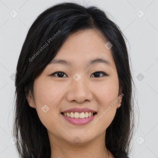 Joyful asian young-adult female with long  brown hair and brown eyes