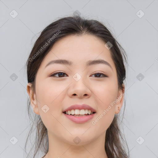 Joyful asian young-adult female with long  brown hair and brown eyes