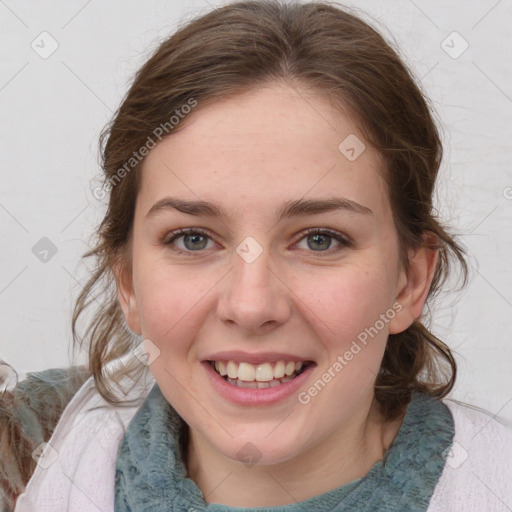 Joyful white young-adult female with medium  brown hair and grey eyes