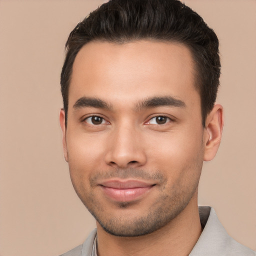 Joyful white young-adult male with short  black hair and brown eyes