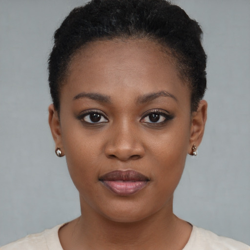 Joyful black young-adult female with short  brown hair and brown eyes