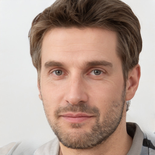 Joyful white adult male with short  brown hair and grey eyes