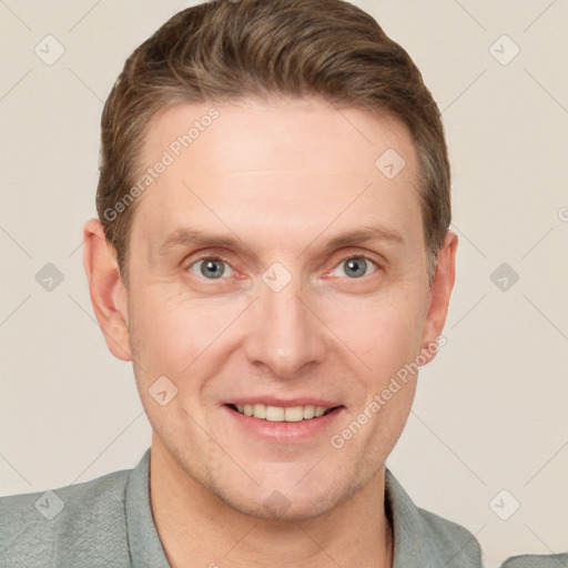 Joyful white adult male with short  brown hair and grey eyes