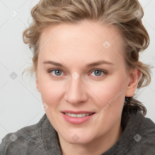 Joyful white young-adult female with medium  brown hair and blue eyes