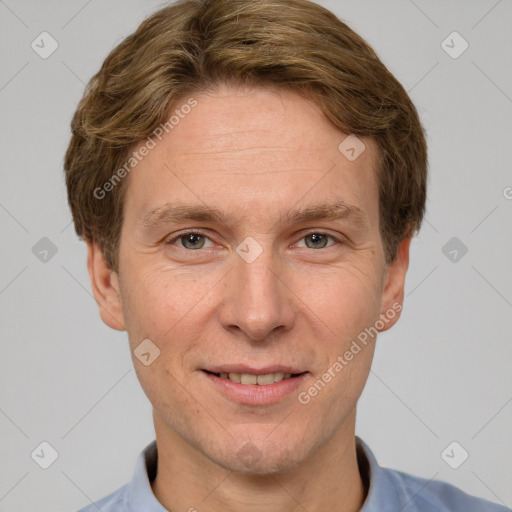 Joyful white adult male with short  brown hair and grey eyes