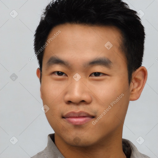 Joyful asian young-adult male with short  black hair and brown eyes