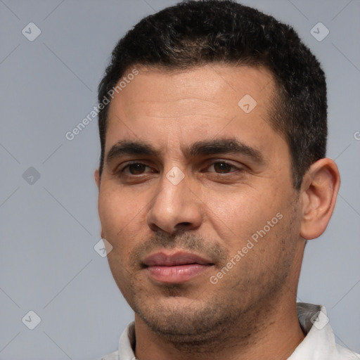 Joyful white young-adult male with short  black hair and brown eyes