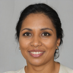 Joyful black young-adult female with medium  brown hair and brown eyes