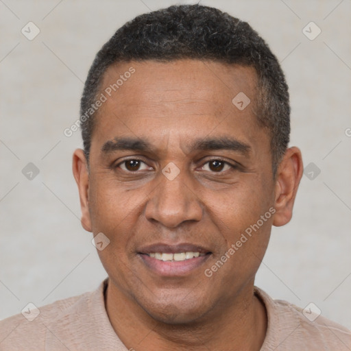 Joyful black adult male with short  black hair and brown eyes