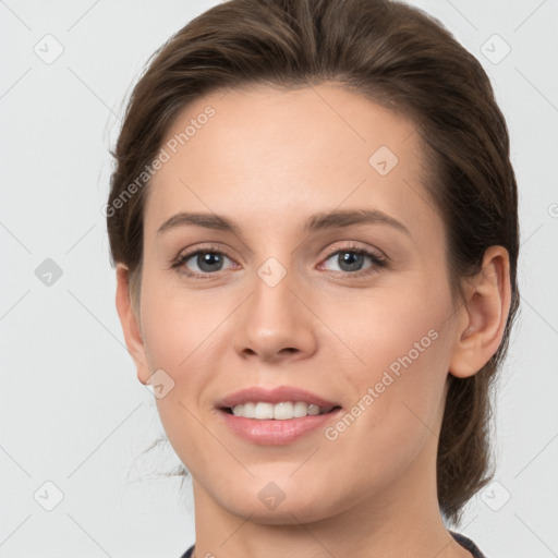 Joyful white young-adult female with medium  brown hair and grey eyes