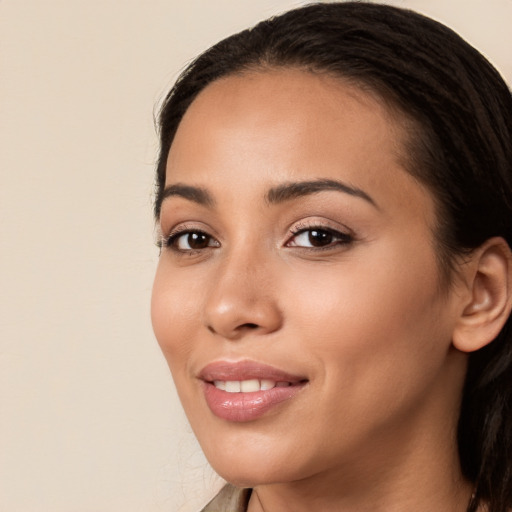 Joyful white young-adult female with long  brown hair and brown eyes