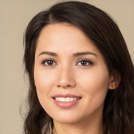 Joyful white young-adult female with long  brown hair and brown eyes