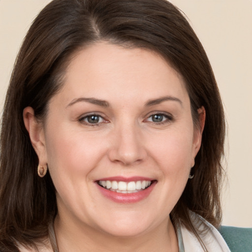 Joyful white young-adult female with medium  brown hair and brown eyes