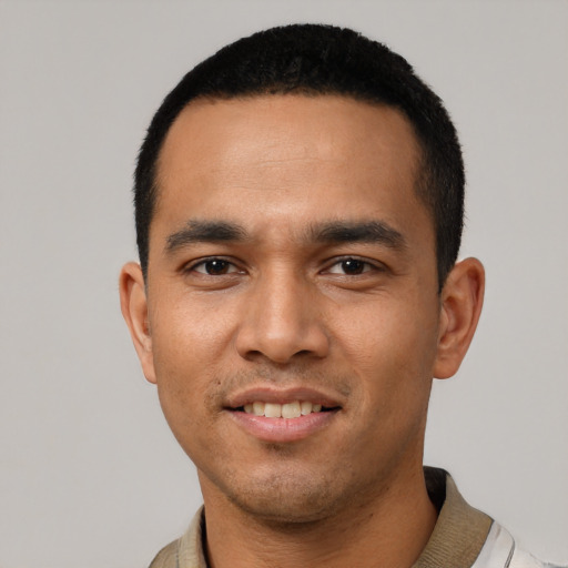 Joyful latino young-adult male with short  black hair and brown eyes