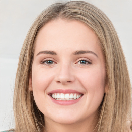 Joyful white young-adult female with long  brown hair and green eyes