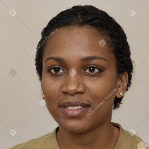 Joyful black young-adult female with short  black hair and brown eyes