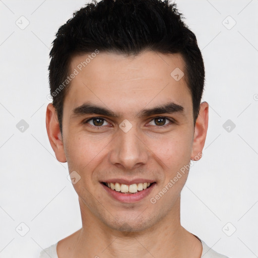 Joyful white young-adult male with short  black hair and brown eyes