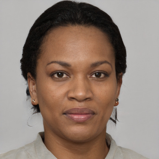 Joyful black adult female with short  brown hair and brown eyes