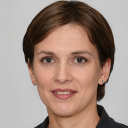 Joyful white adult female with medium  brown hair and grey eyes