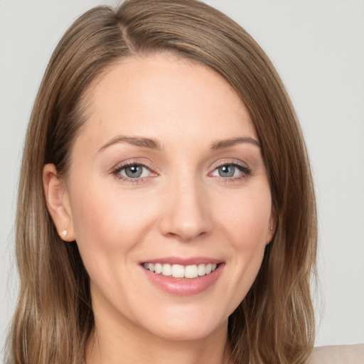 Joyful white young-adult female with long  brown hair and grey eyes