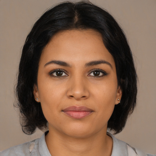 Joyful latino young-adult female with medium  black hair and brown eyes