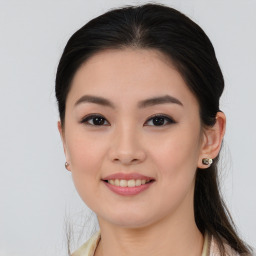 Joyful asian young-adult female with long  brown hair and brown eyes