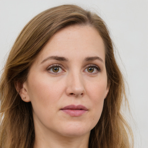 Joyful white young-adult female with long  brown hair and green eyes