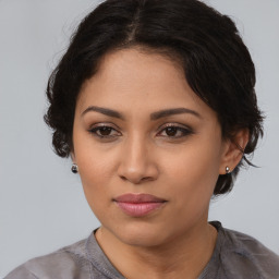 Joyful latino young-adult female with medium  brown hair and brown eyes